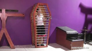 Twinky boy Merlin is handcuffed in the coffin cage