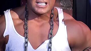 Muscular construction worker is bound with chains